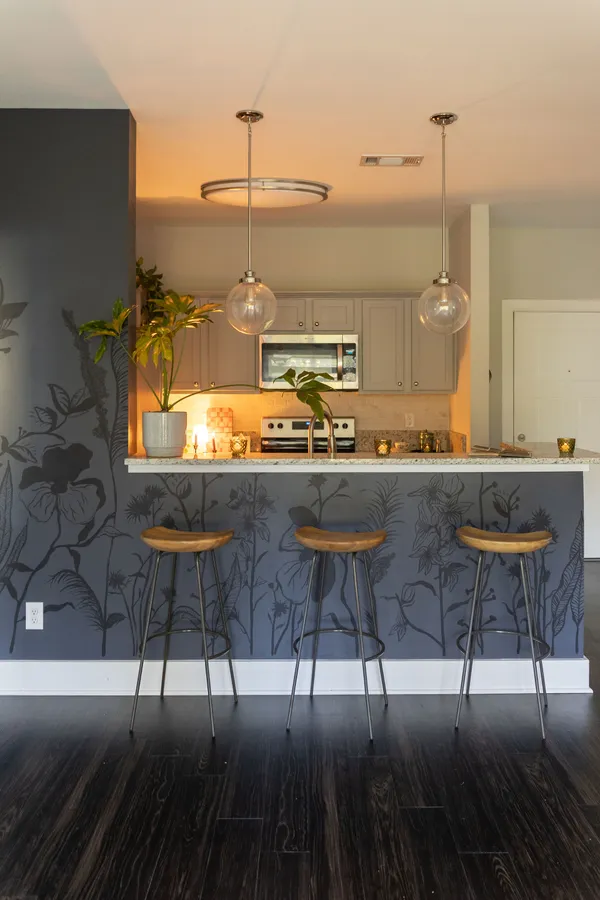 a kitchen with a sink and chairs