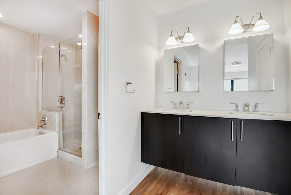 2098 Frederick Douglass Boulevard, Unit 7M Manhattan, NY 10026 - Photo 8 of 15 a bathroom with a sink vanity tub and shower