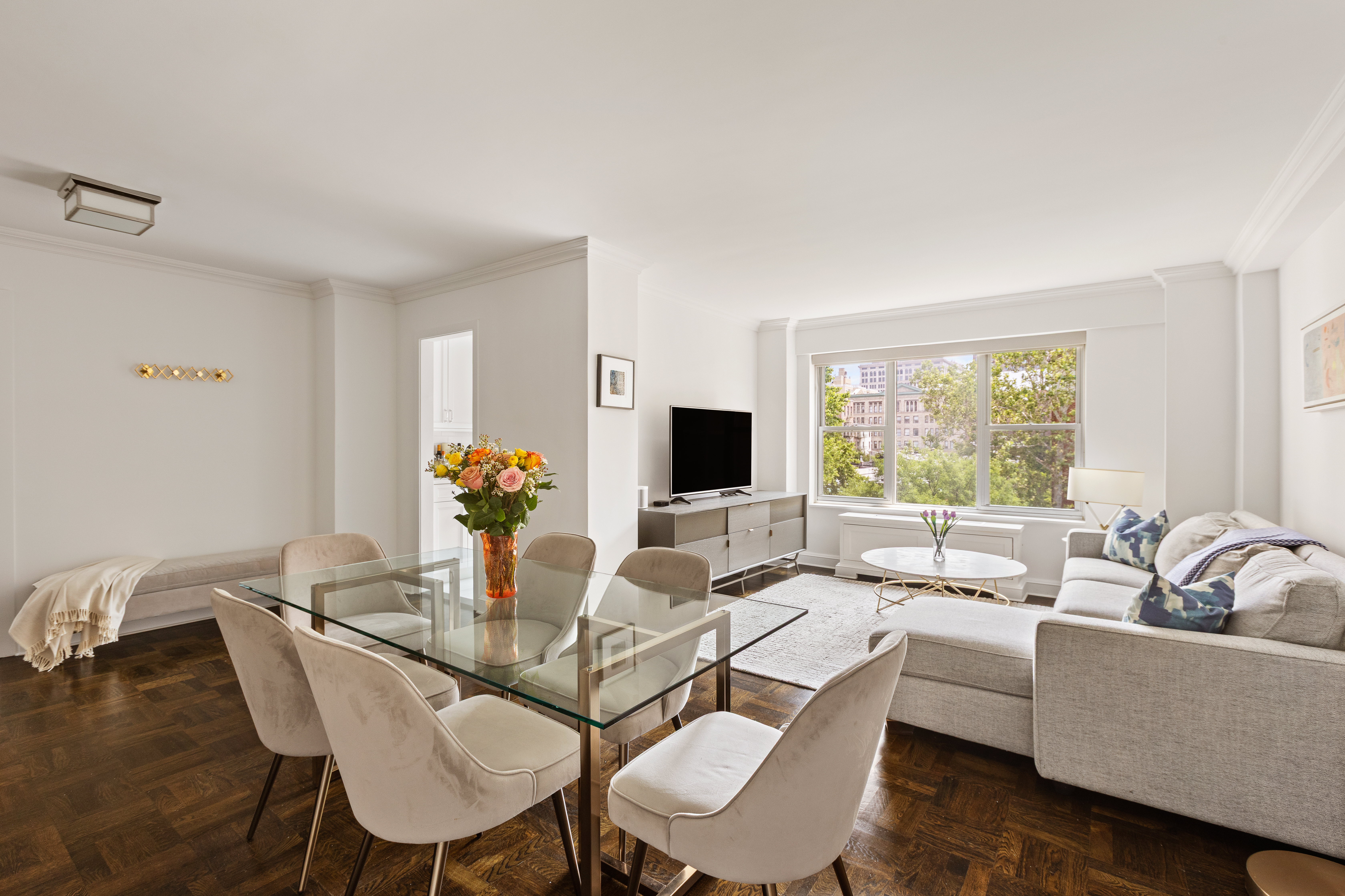 2 5th Avenue, Unit 5F Manhattan, NY 10011 - Photo 2 of 9 a living room with furniture and a flat screen tv