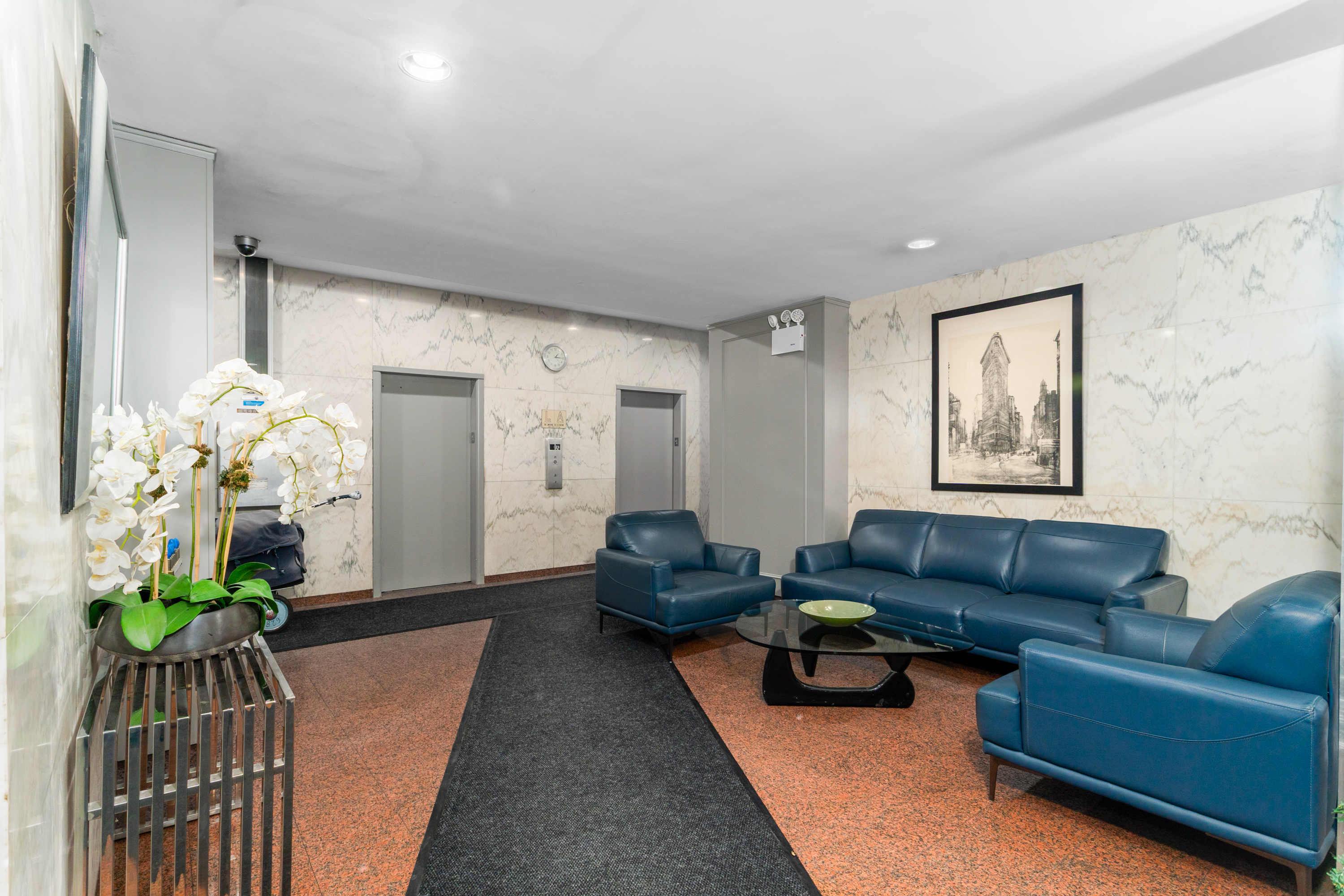 315 East 65th Street, Unit 8F Manhattan, NY 10065 - Photo 9 of 11 a living room with furniture and a chandelier