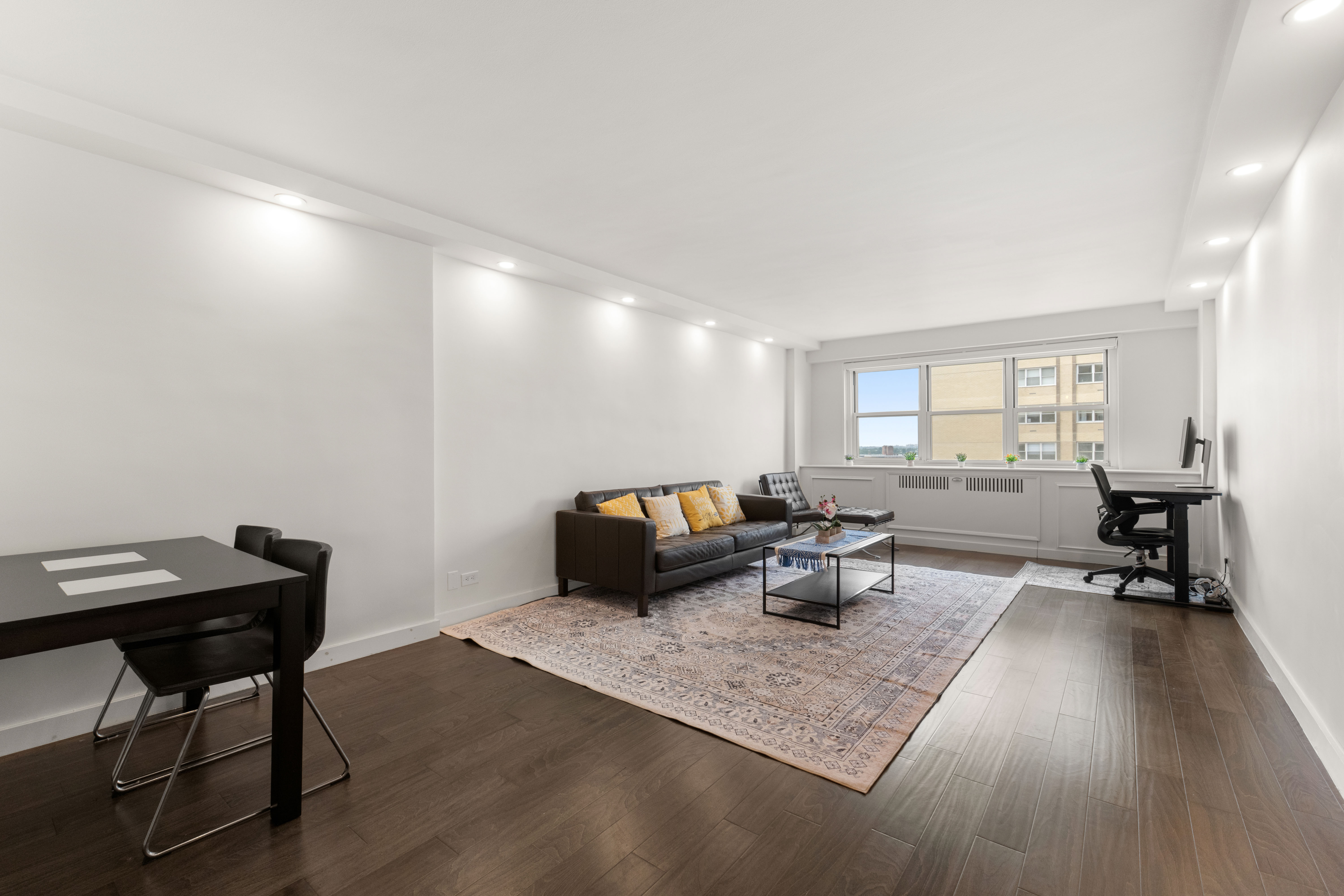 66-36 Yellowstone Boulevard, Unit 24A Queens, NY 11375 - Photo 3 of 20 a living room with furniture and a wooden floor