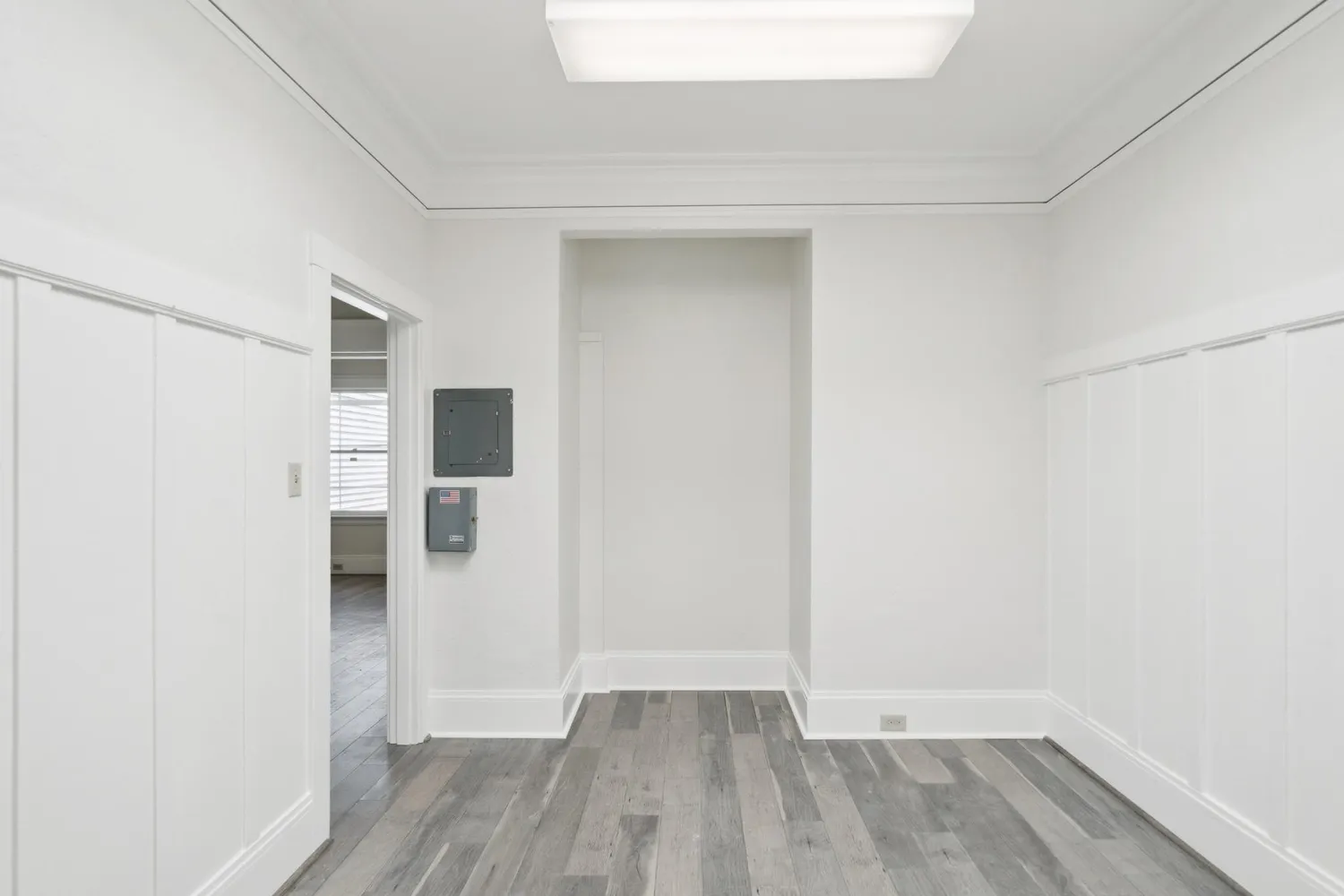a view of a hallway with wooden floor