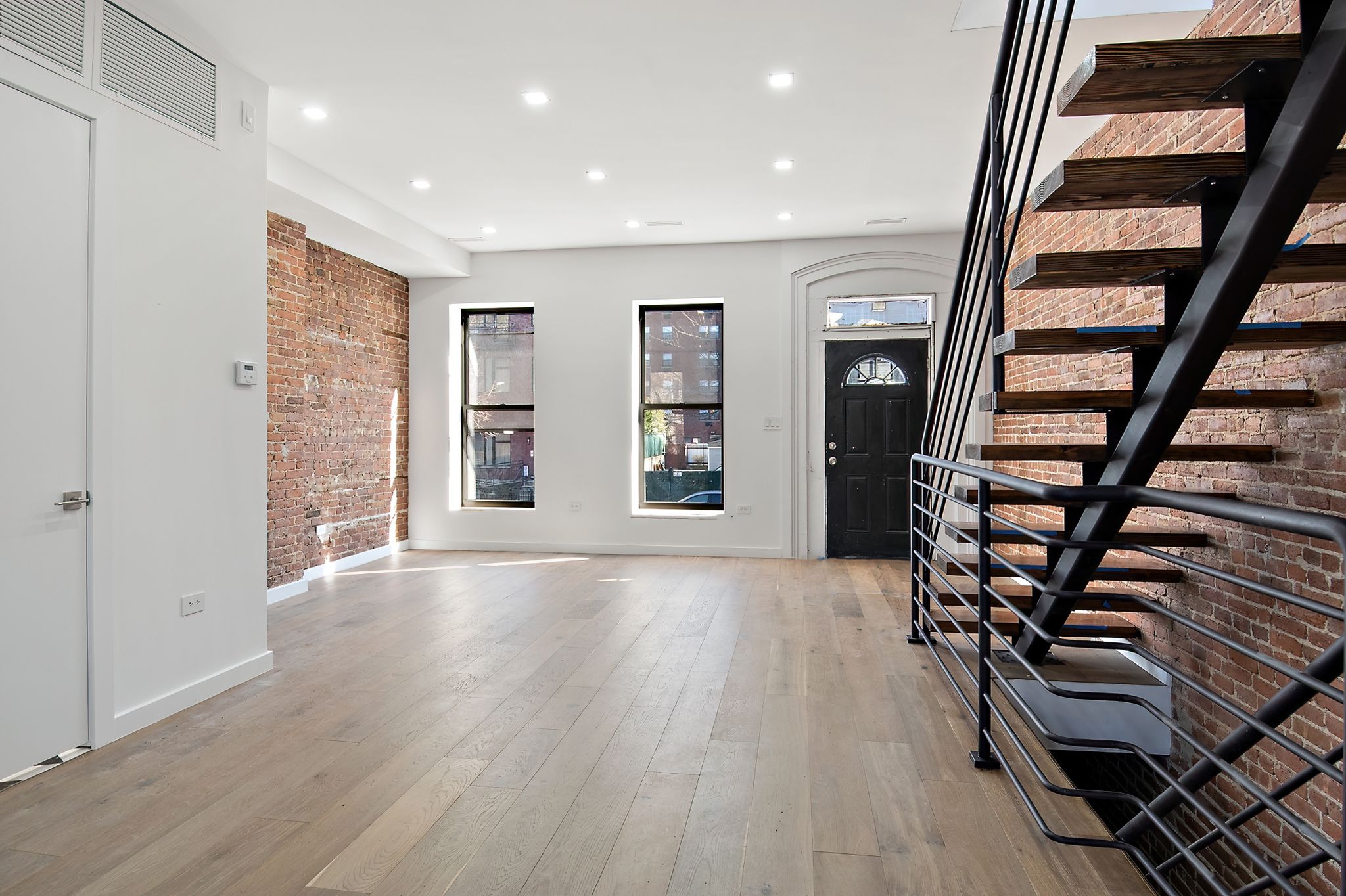 181 Kosciuszko Street Brooklyn, NY 11216 - Photo 5 of 20 wooden floor in an empty room with a window