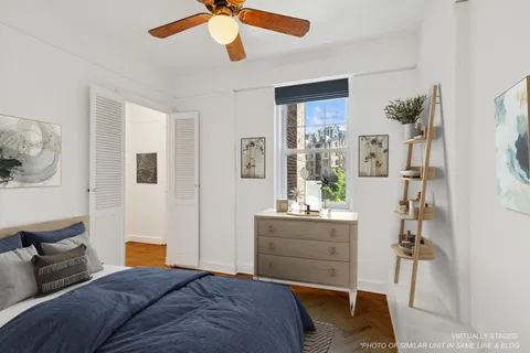 a bedroom with furniture and a chandelier