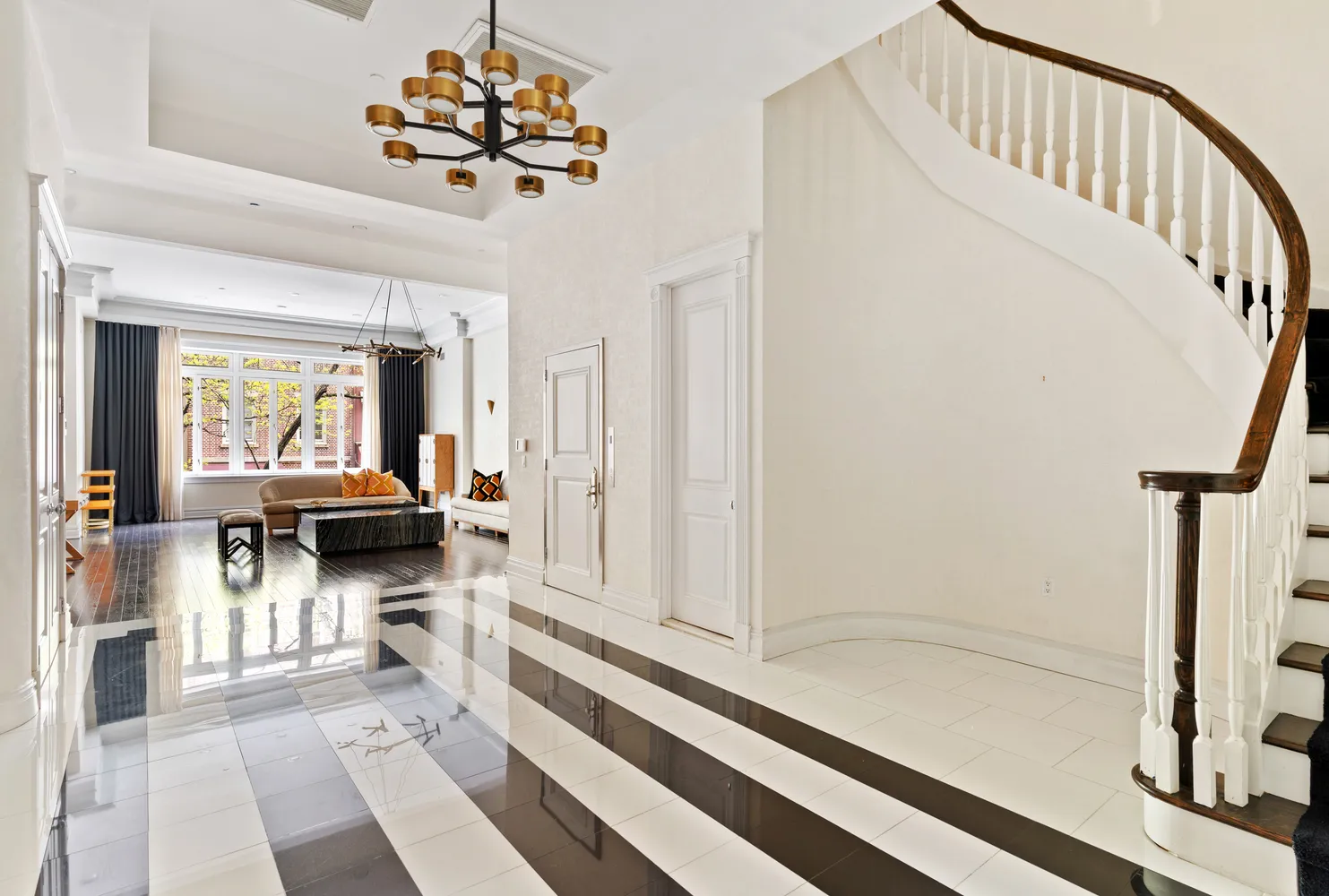 a living room with furniture and a chandelier