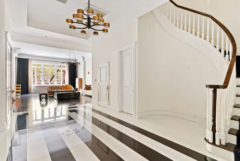 a living room with furniture and a chandelier