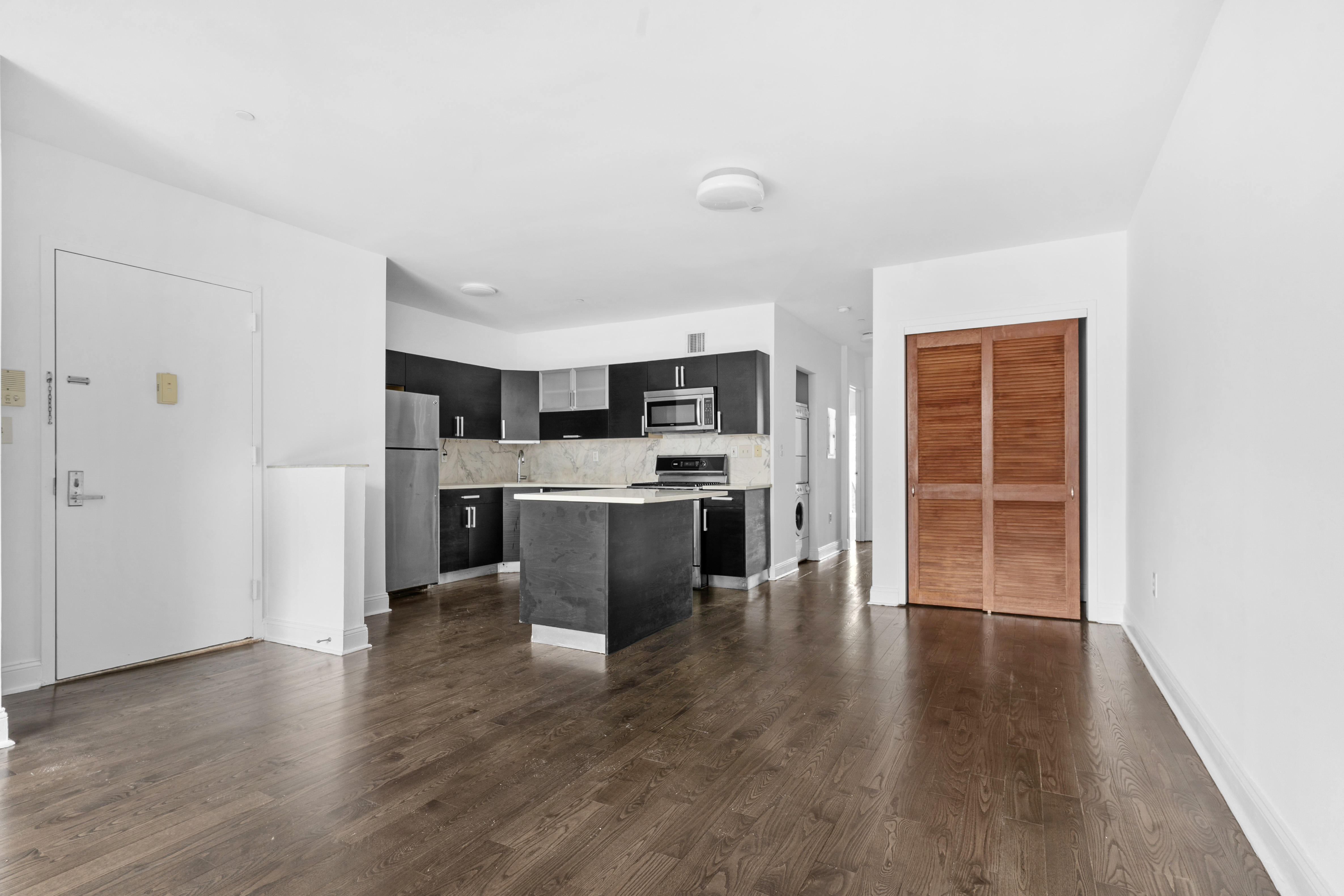 269 8th Street, Unit 2R Brooklyn, NY 11215 - Photo 4 of 14 a view of kitchen with stainless steel appliances granite countertop a stove top oven a sink dishwasher and a refrigerator with wooden floor