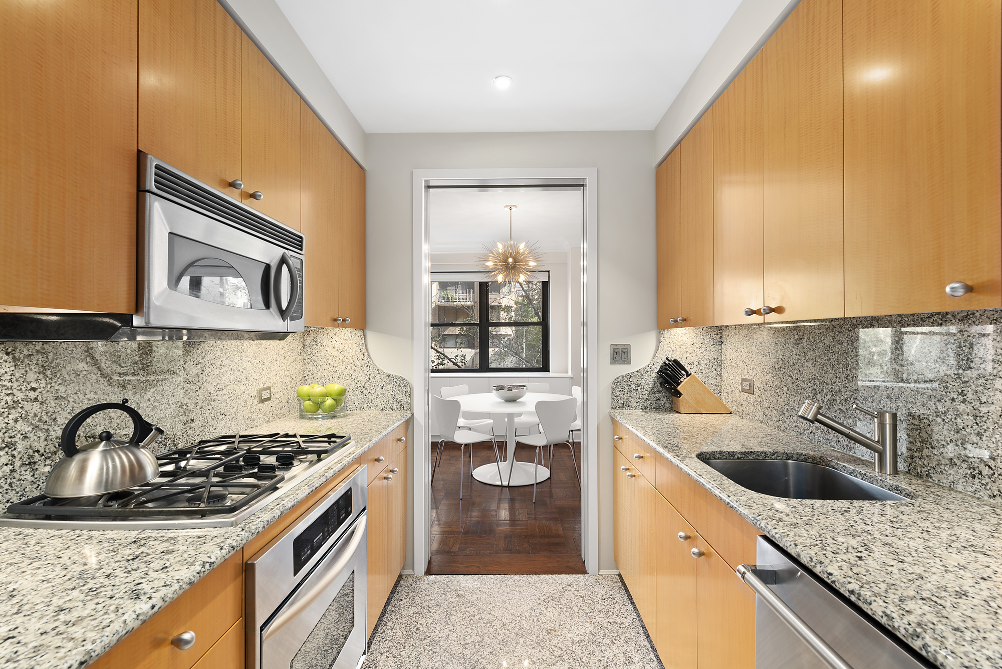 165 East 72nd Street, Unit 3L Manhattan, NY 10021 - Photo 3 of 13 a kitchen with a sink stove and cabinets