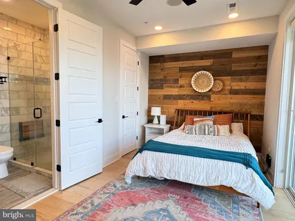 a bedroom with a bed and a shower