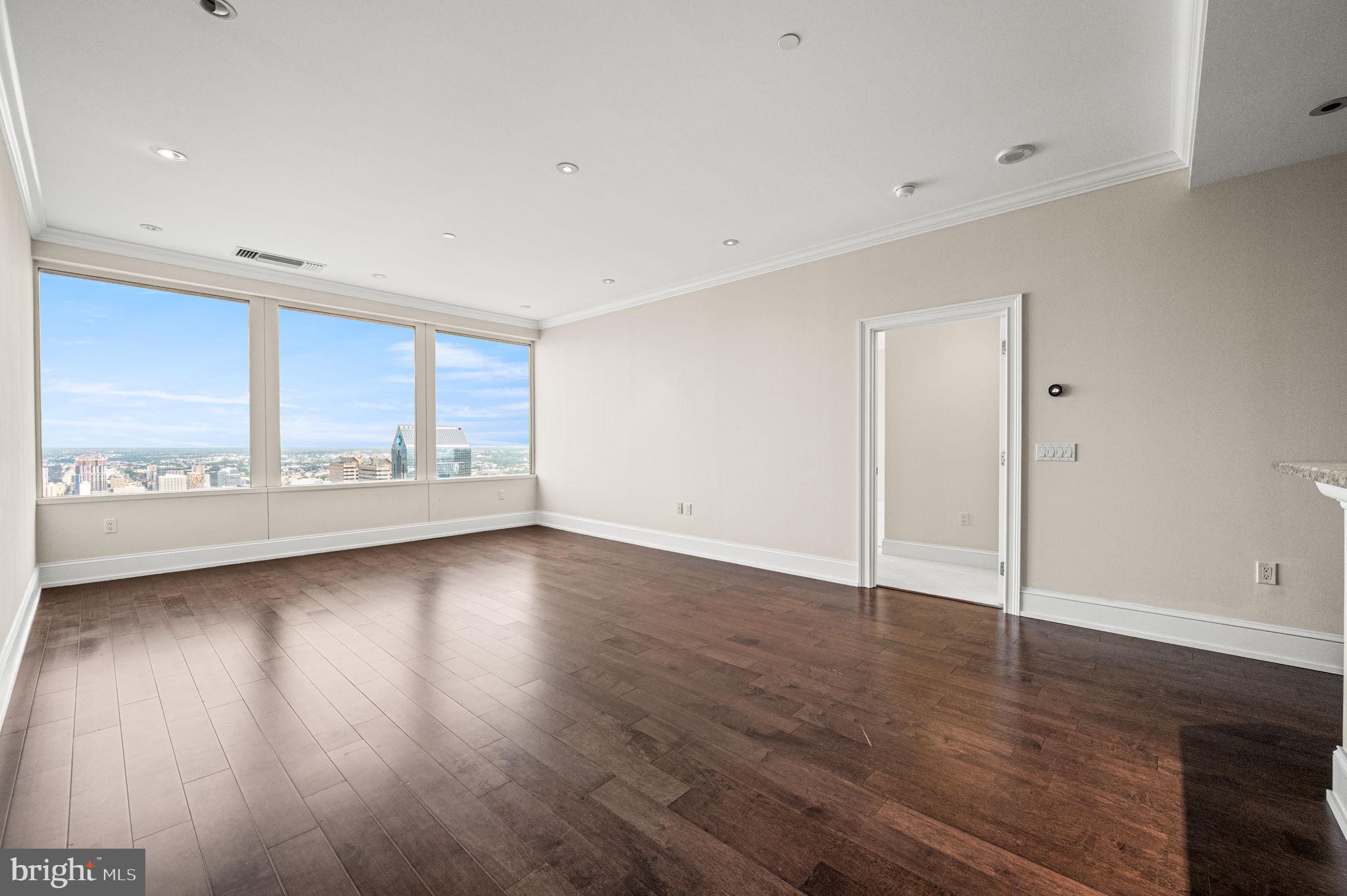 50 South 16th Street, Unit 4503 Philadelphia, PA 19103 - Photo 8 of 31 an empty room with wooden floor and windows