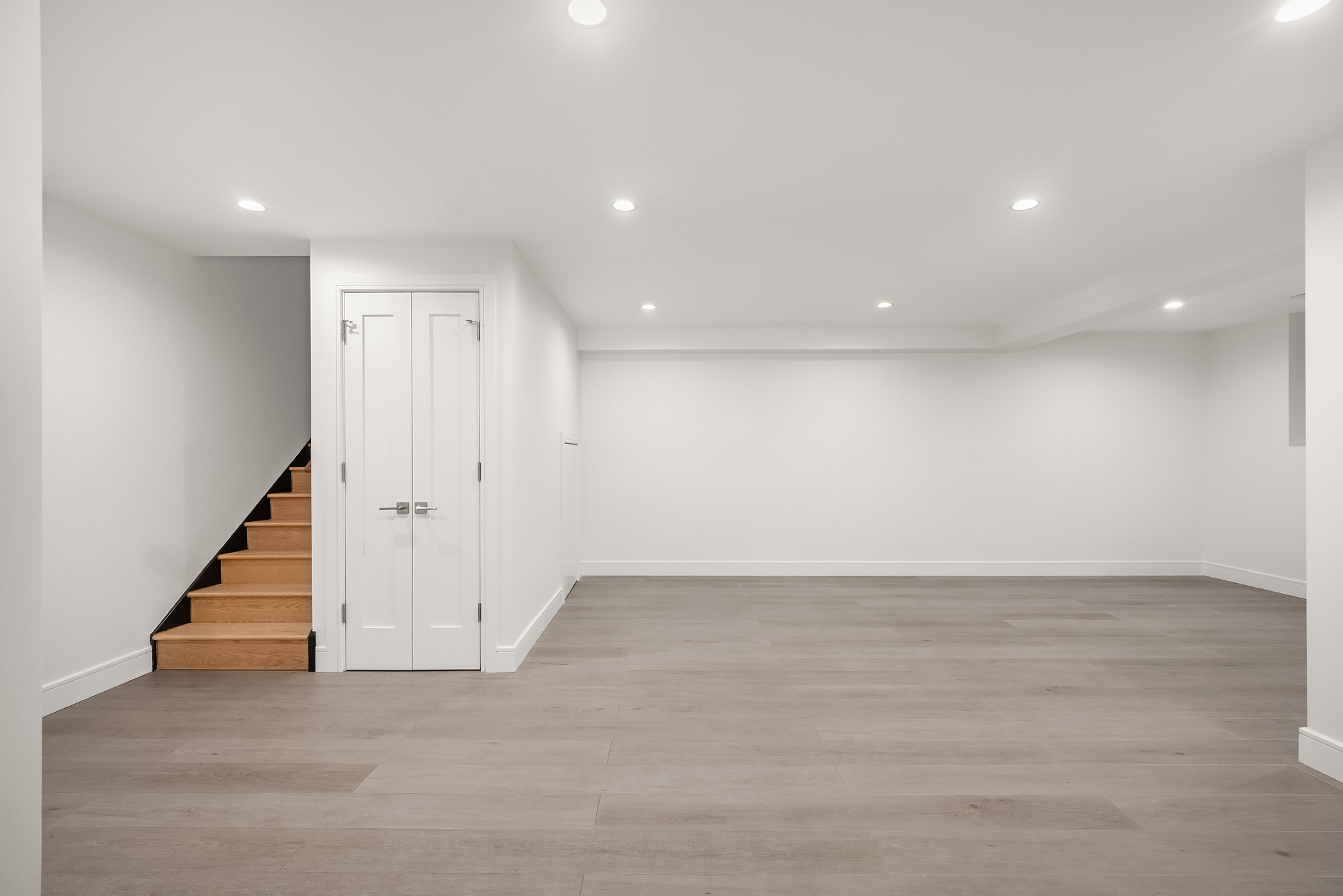 45 Garnet Street, Unit 1A Brooklyn, NY 11231 - Photo 8 of 13 an empty room with wooden floor and stairs