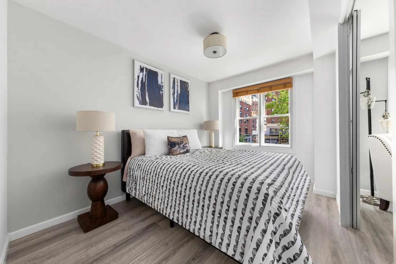 a bedroom with bed and wooden floor