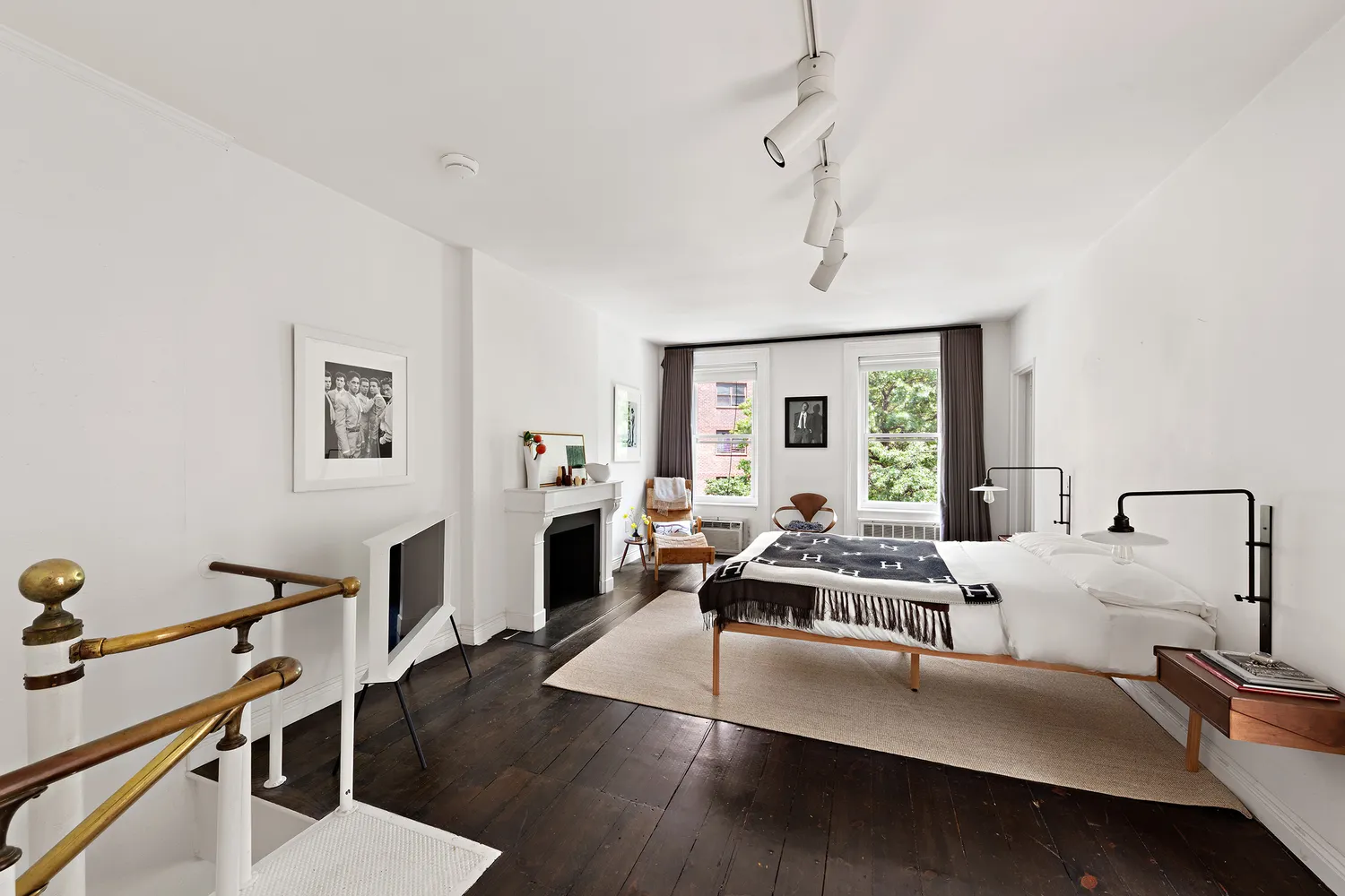 a living room with furniture flat screen tv and window