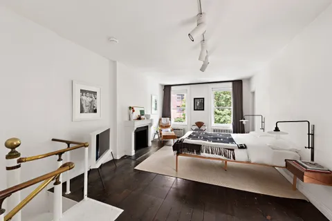 a living room with furniture flat screen tv and window