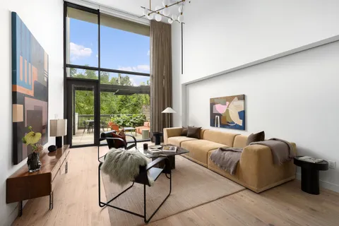a living room with furniture large window and flat screen tv