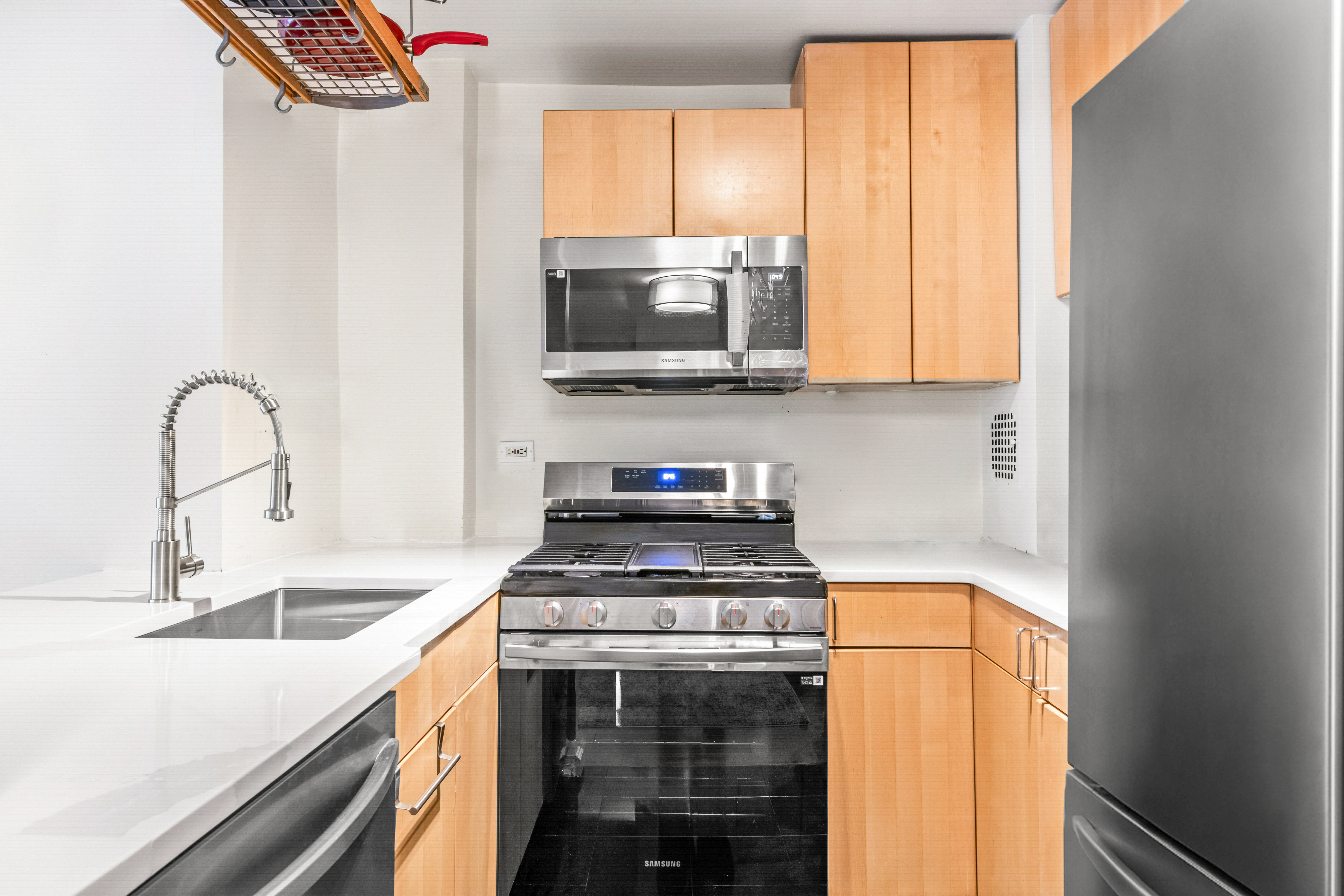 165 Christopher Street, Unit 5AA Manhattan, NY 10014 - Photo 4 of 9 a kitchen with a stove and a sink