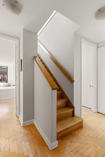 a view of entryway and hall with wooden floor