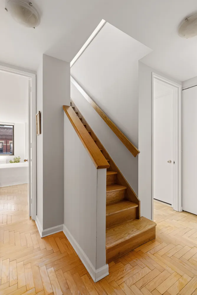 a view of entryway and hall with wooden floor