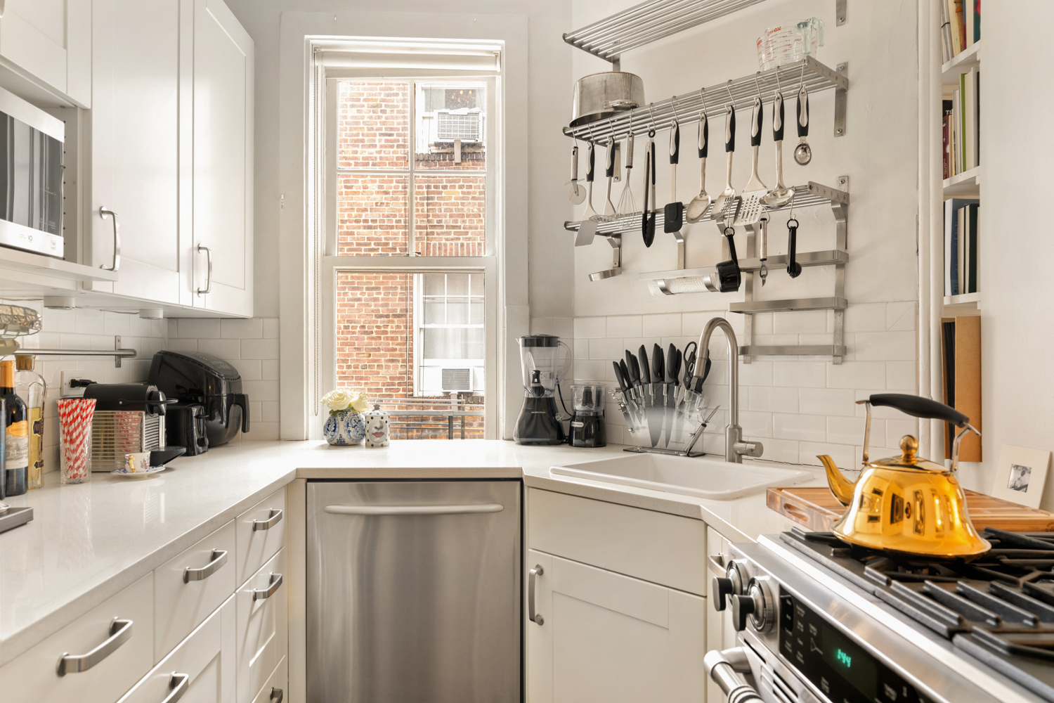 78 Bedford Street, Unit 4C Manhattan, NY 10014 - Photo 5 of 10 a kitchen with stainless steel appliances a sink and a window