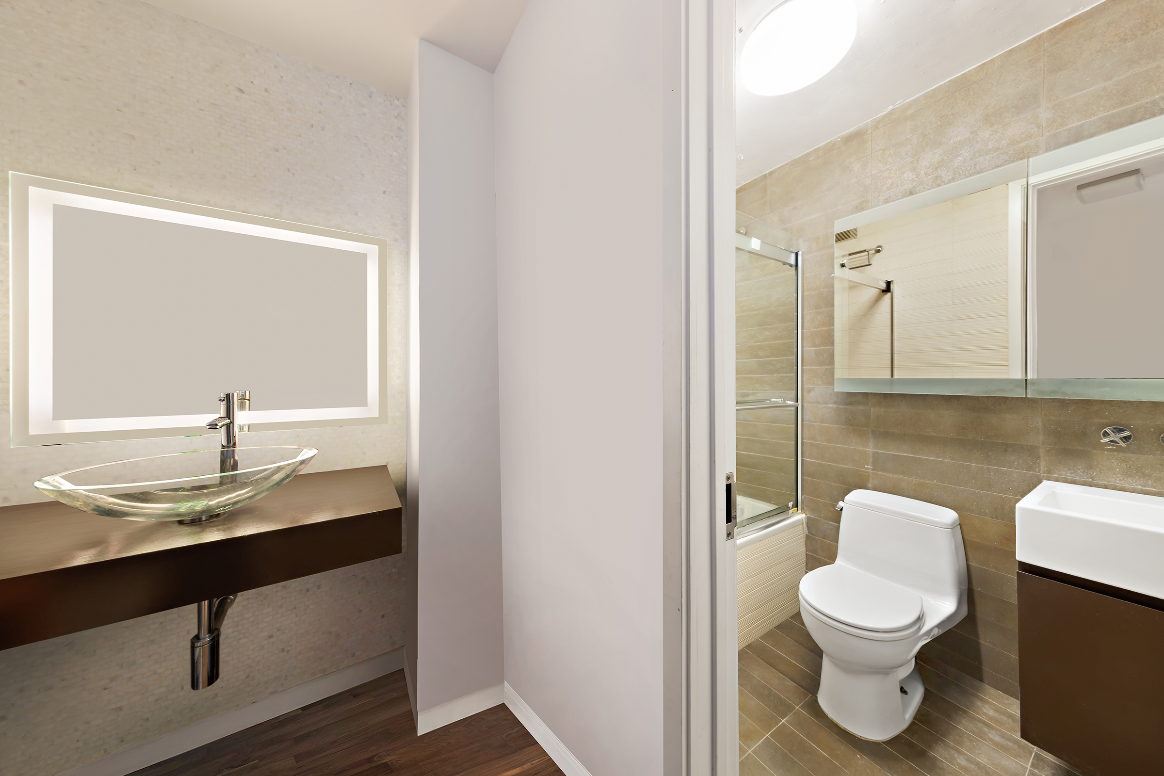 515 East 72nd Street, Unit 3KLMN Manhattan, NY 10021 - Photo 9 of 29 a bathroom with a toilet a sink and mirror