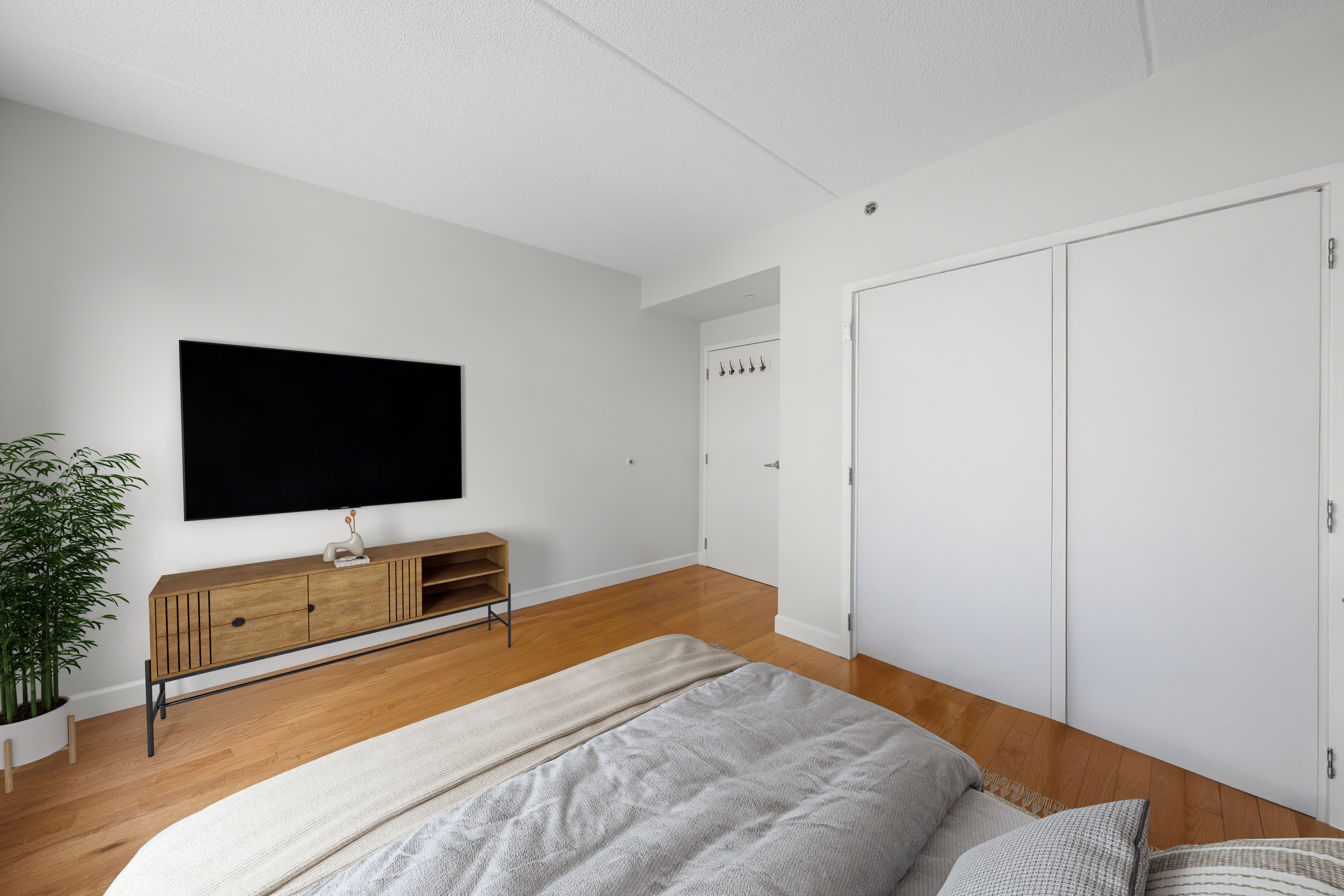 40 West 116th Street, Unit B301 Manhattan, NY 10026 - Photo 8 of 17 a bedroom with a bed and a flat screen tv