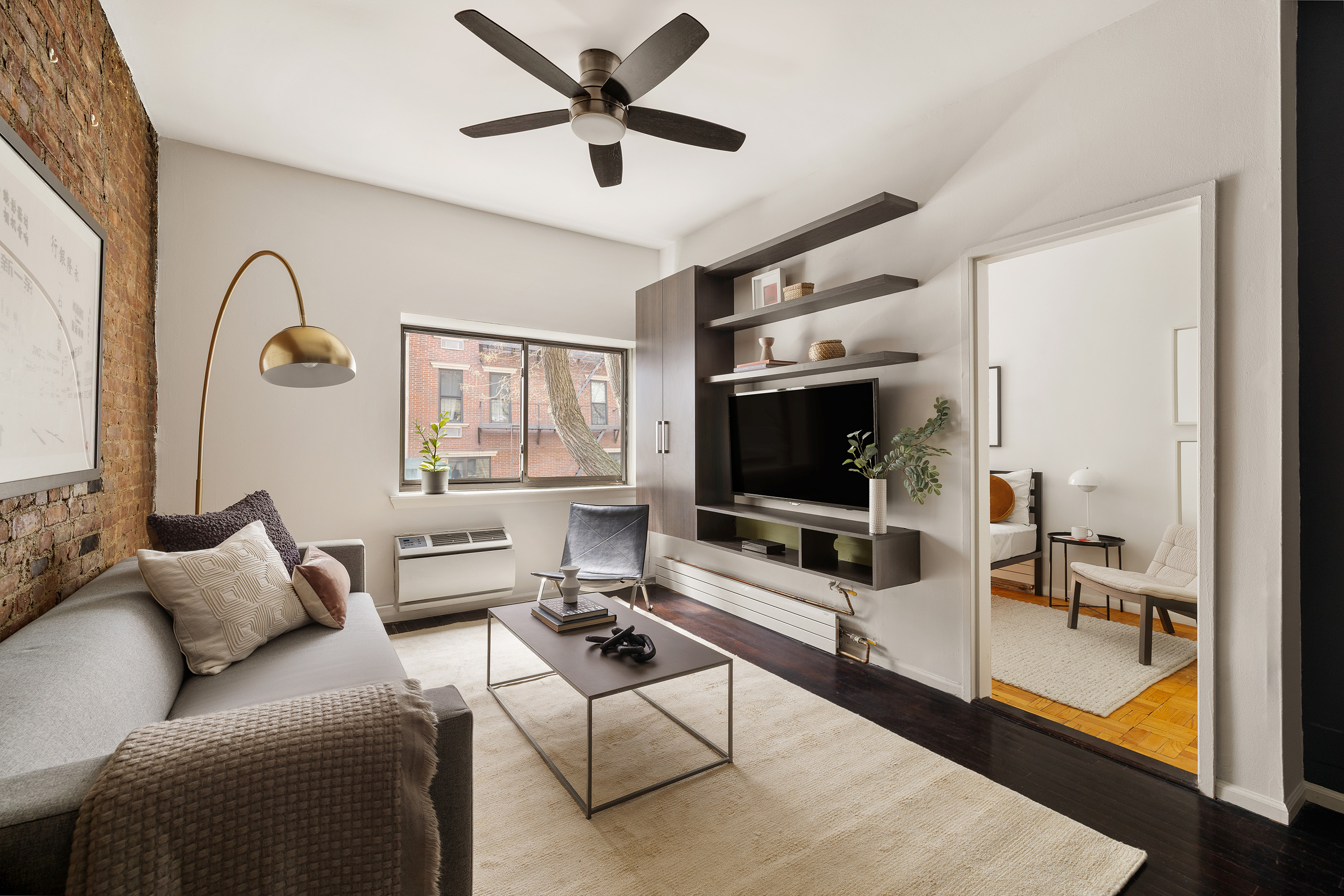 207 East 21st Street, Unit 2A Manhattan, NY 10010 - Photo 2 of 7 a living room with furniture and a flat screen tv