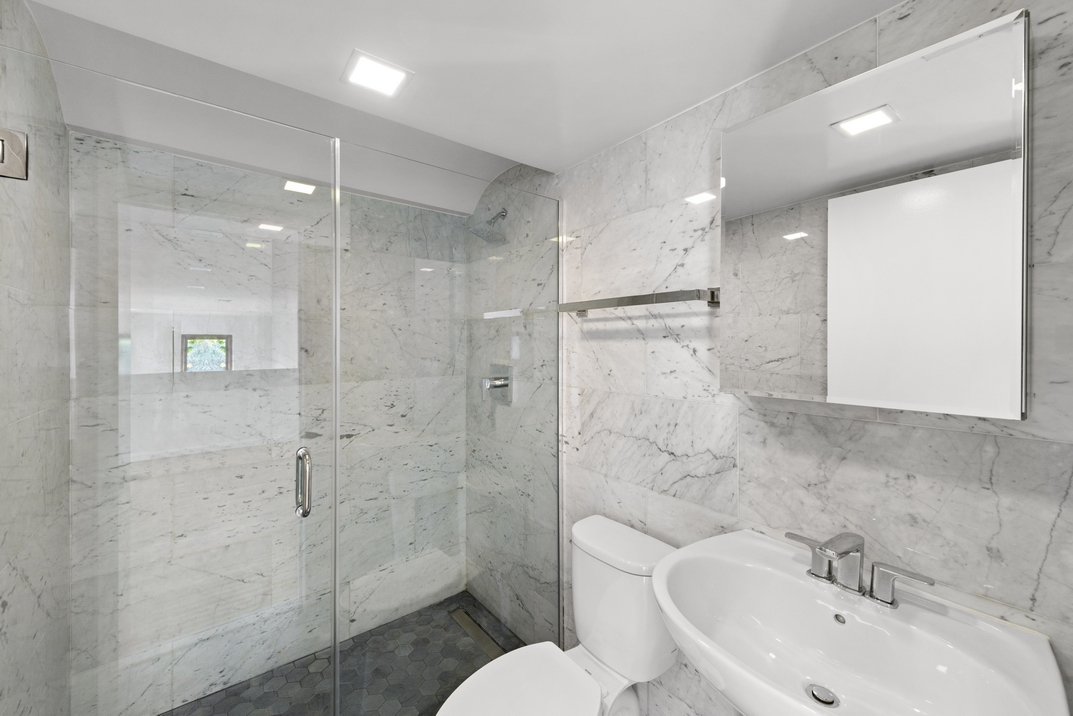 305 2nd Avenue, Unit 505 Manhattan, NY 10003 - Photo 11 of 17 a bathroom with a sink toilet and shower