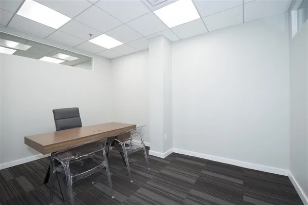 a view of a workspace with wooden floor