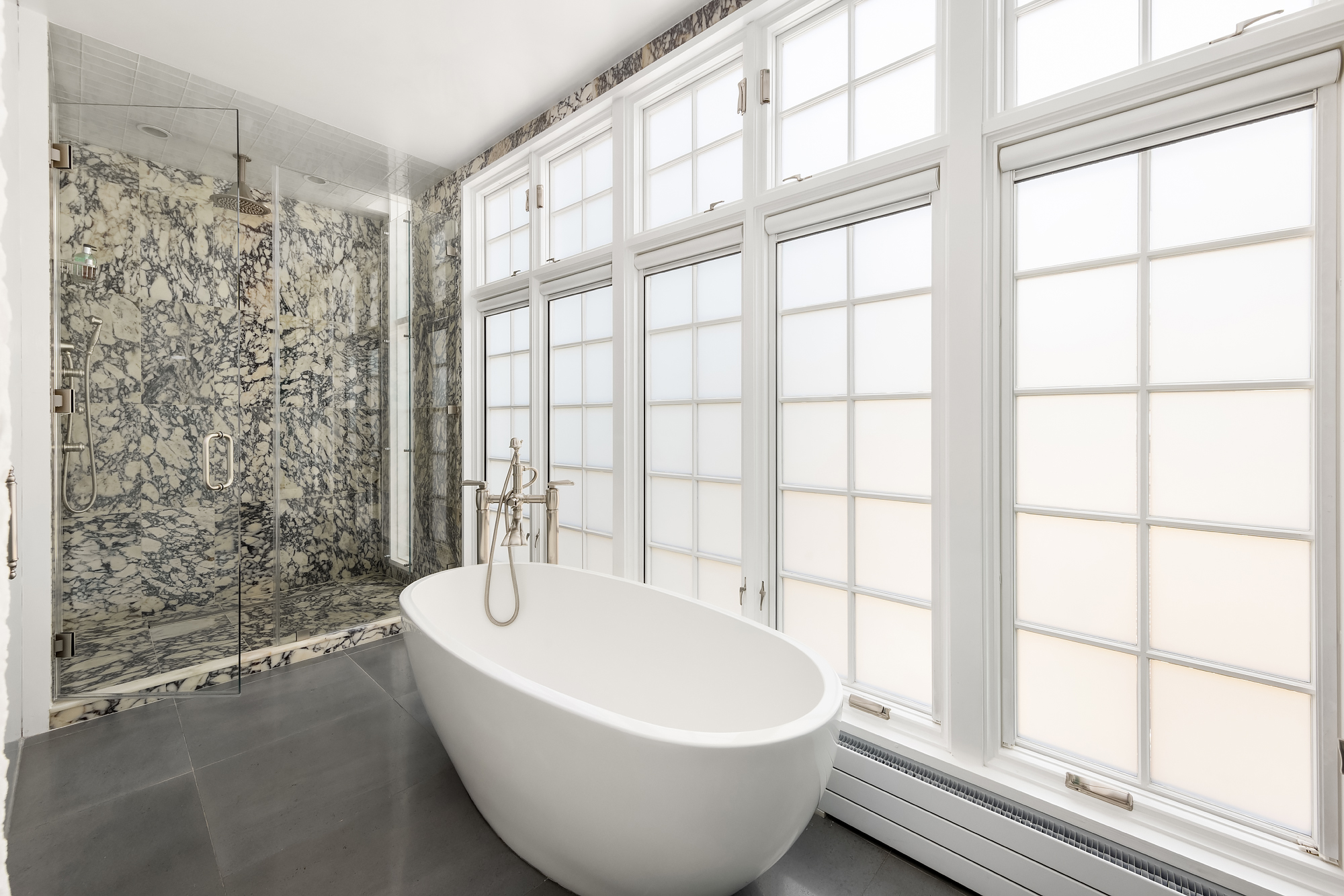 21 Cornelia Street Manhattan, NY 10014 - Photo 14 of 26 a white bath tub sitting next to a window