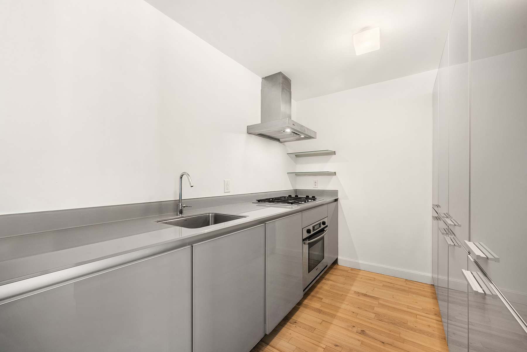 420 West 25th Street, Unit 2K Manhattan, NY 10001 - Photo 7 of 18 a kitchen with stainless steel appliances granite countertop a sink and a stove