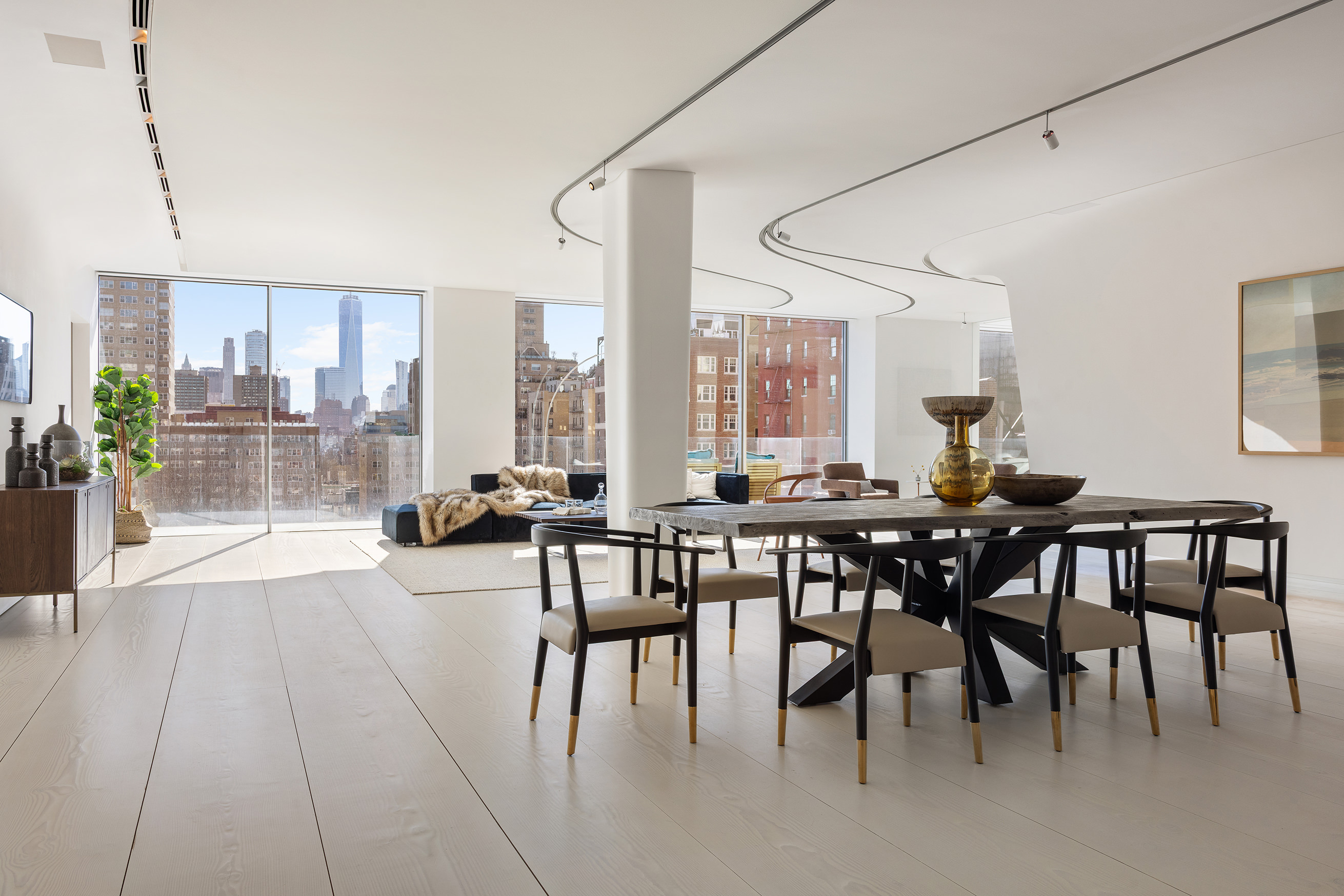 12 East 12th Street, Unit 9NS Manhattan, NY 10003 - Photo 3 of 21 a view of a dining room with furniture and a potted plant