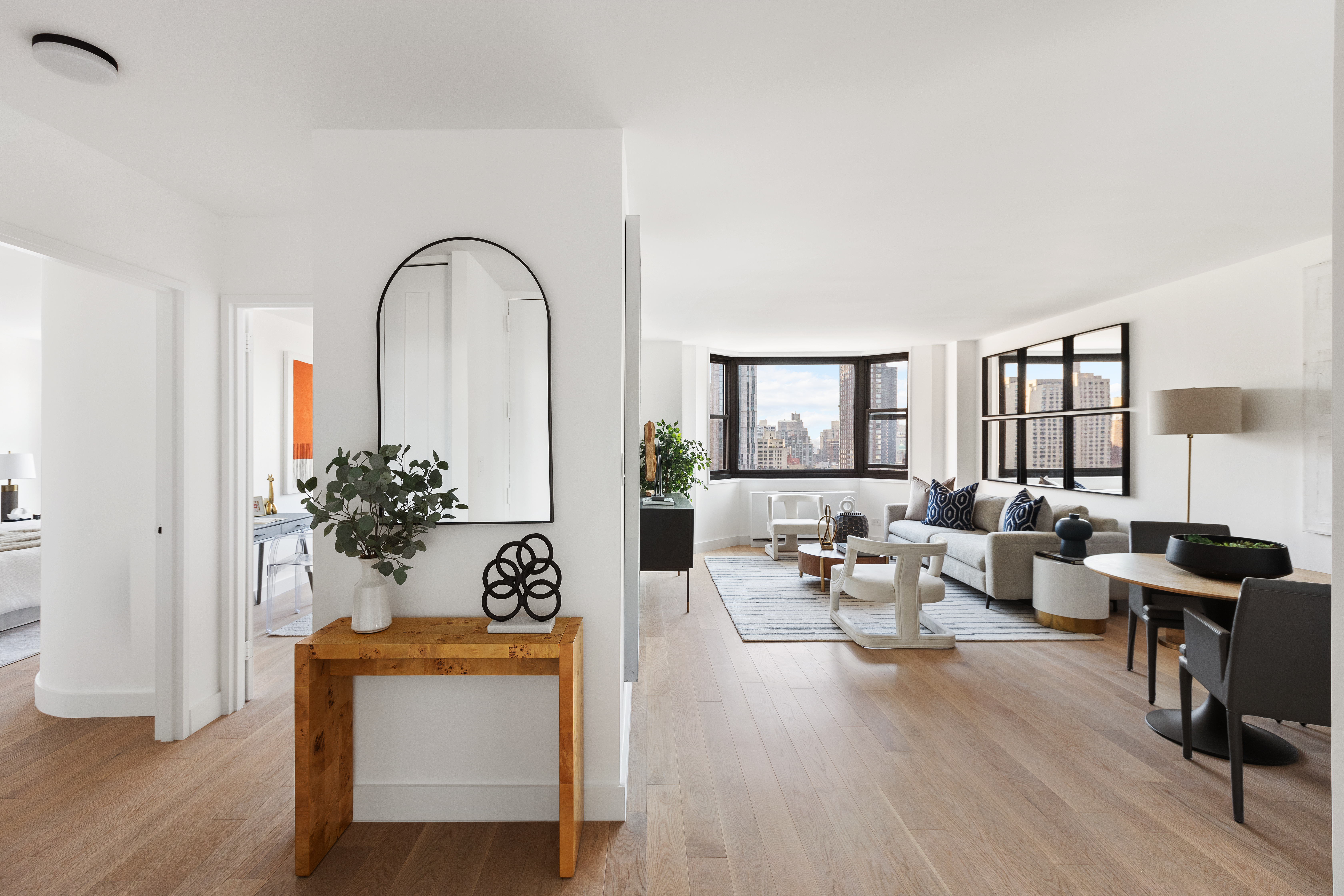 200 East 90th Street, Unit 12F Manhattan, NY 10128 - Photo 8 of 13 a living room with furniture and wooden floor