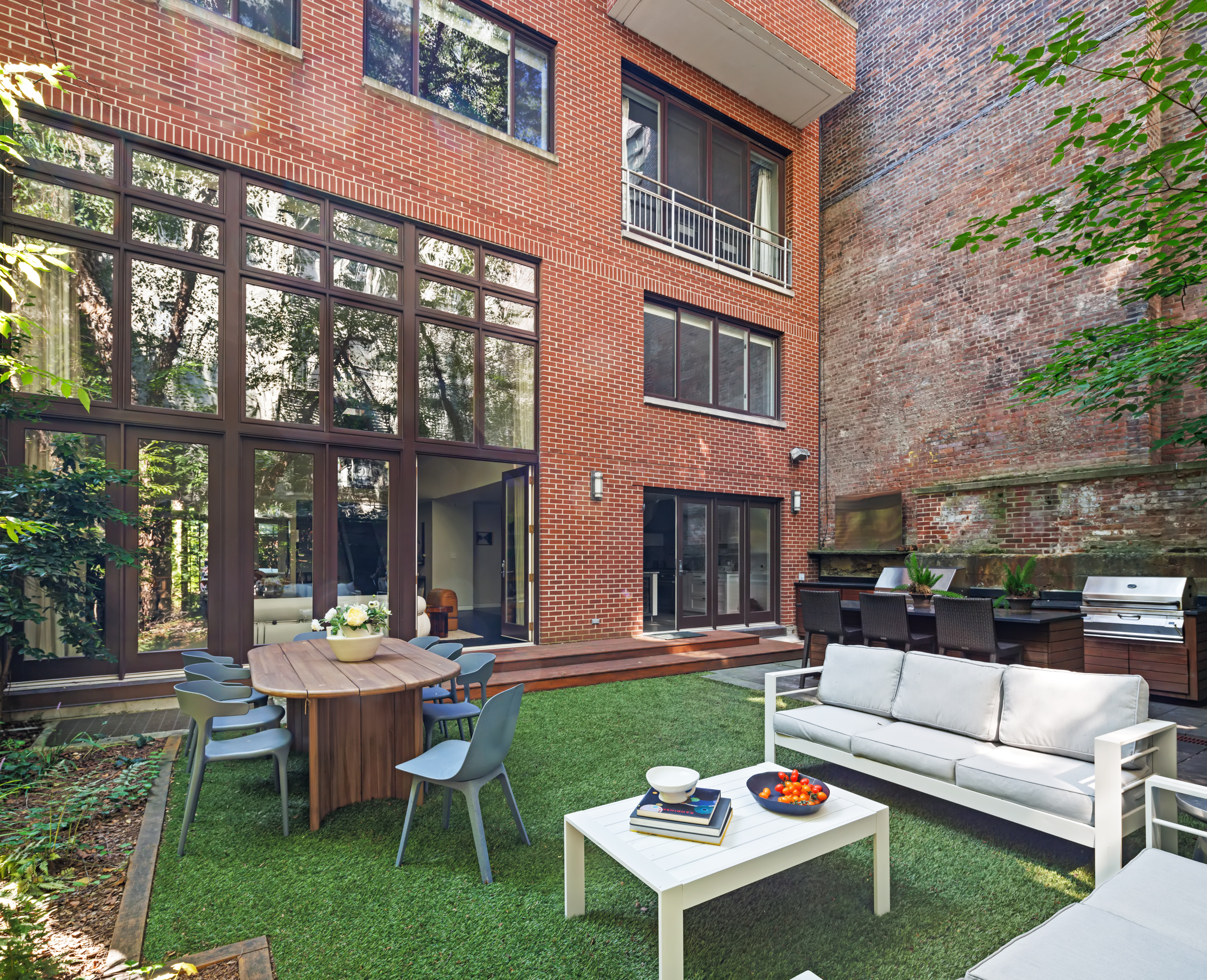 95 Charles Street, Unit TH Manhattan, NY 10014 - Photo 9 of 29 a outdoor space with patio couches and a table and chairs