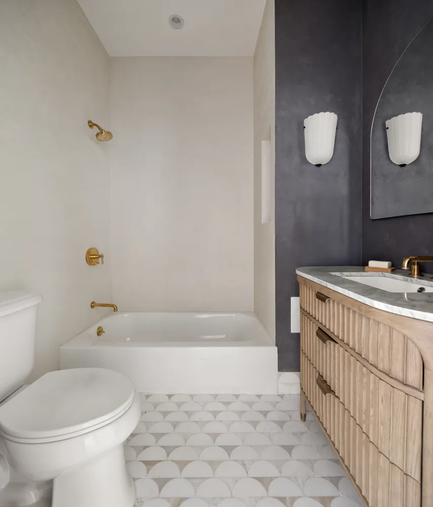 a bathroom with a bathtub sink and toilet