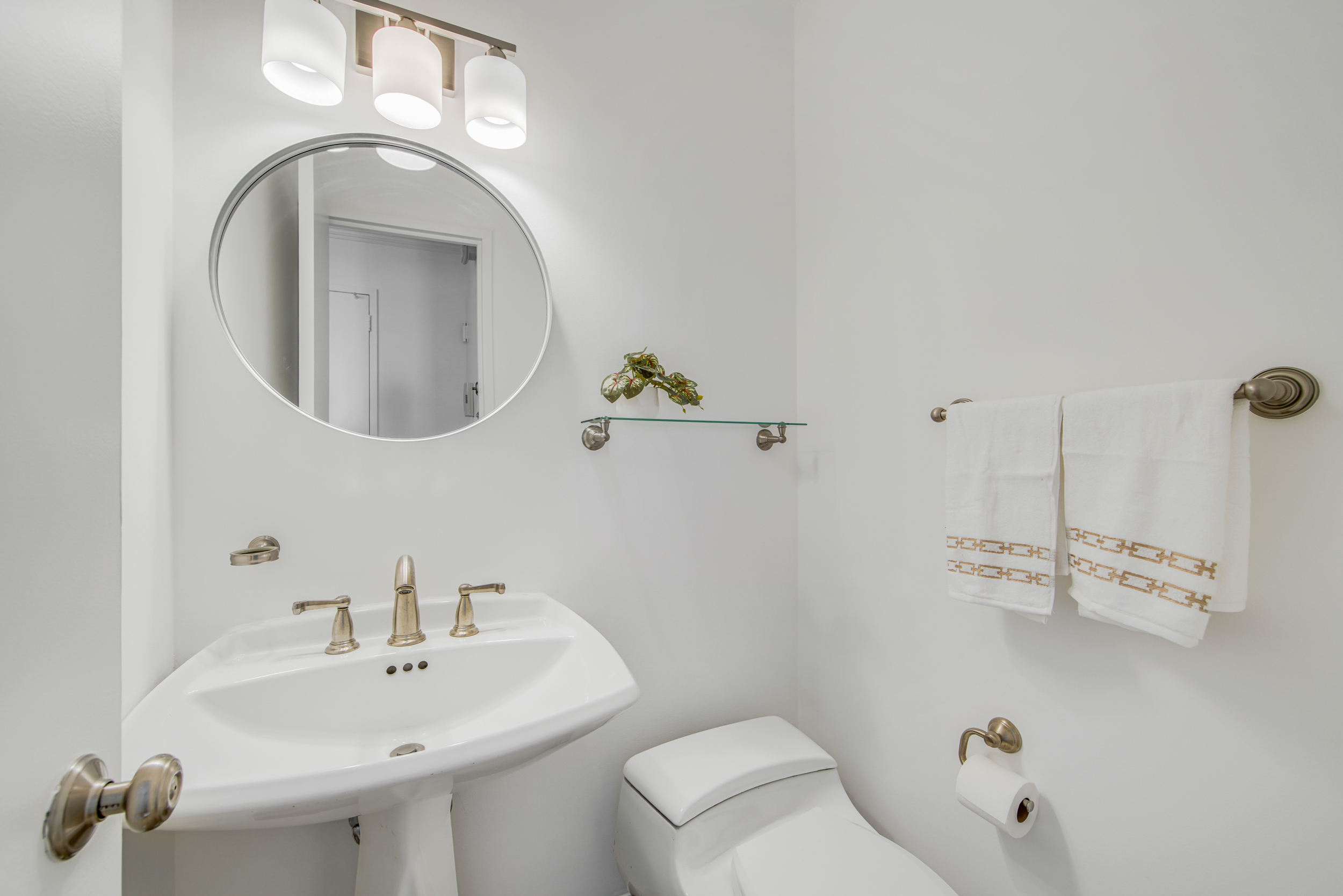 171 East 84th Street, Unit 31C Manhattan, NY 10028 - Photo 12 of 18 a bathroom with a sink a toilet and a mirror