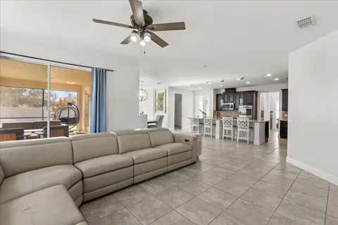 a kitchen with stainless steel appliances kitchen island granite countertop a stove a sink and a refrigerator