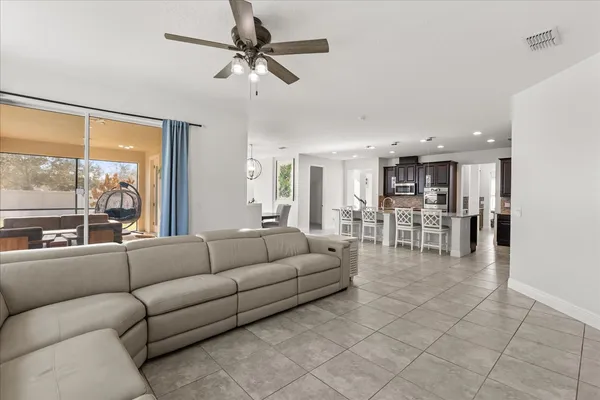 a dining room with furniture a chandelier and window
