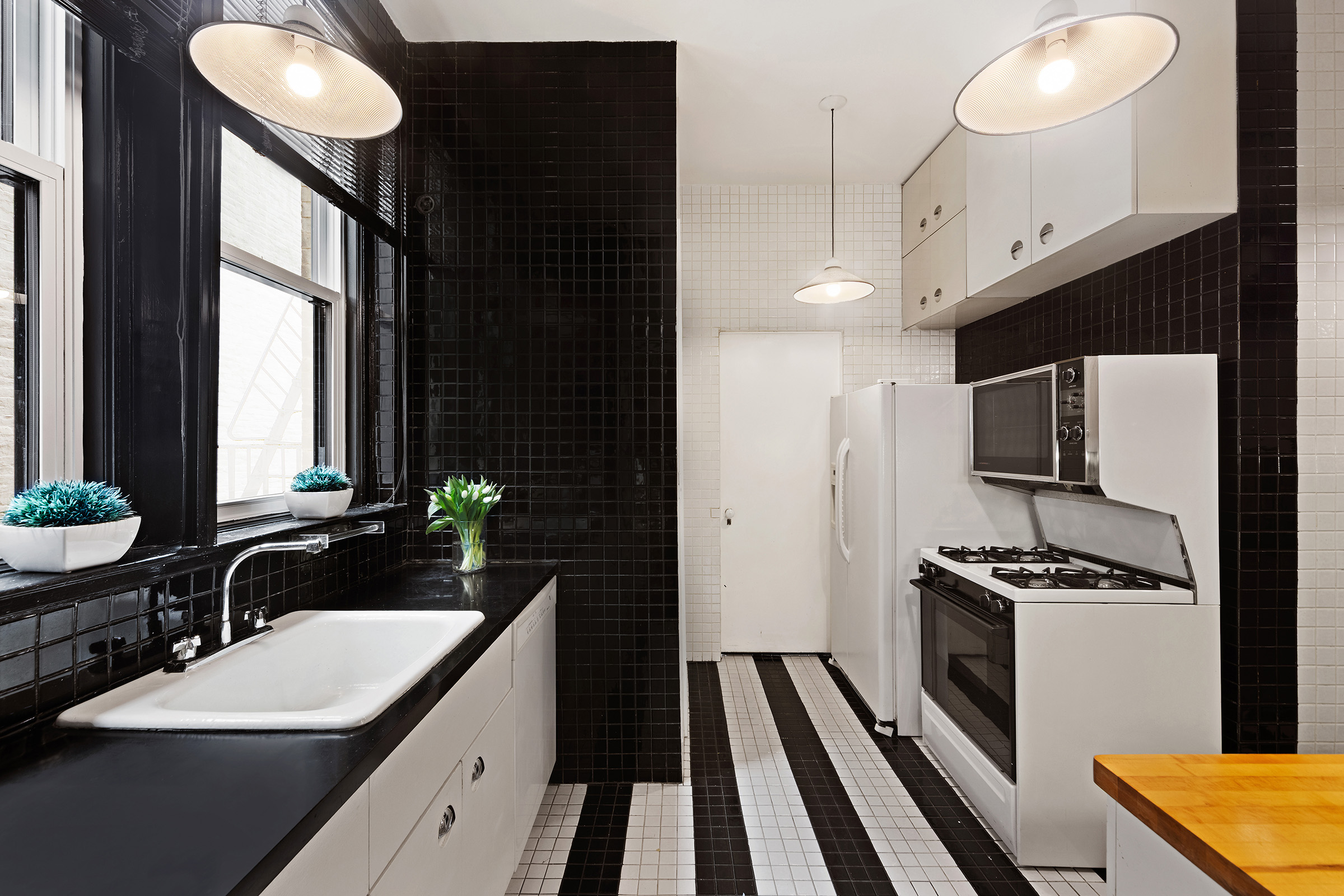 31 East 72nd Street, Unit 4B Manhattan, NY 10021 - Photo 11 of 14 a kitchen with sink refrigerator and stove