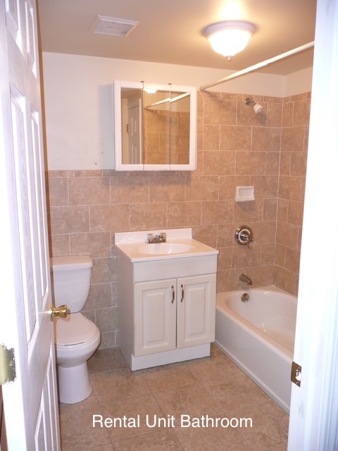 266 18th Street Brooklyn, NY 11215 - Photo 17 of 20 a bathroom with a sink a toilet and shower