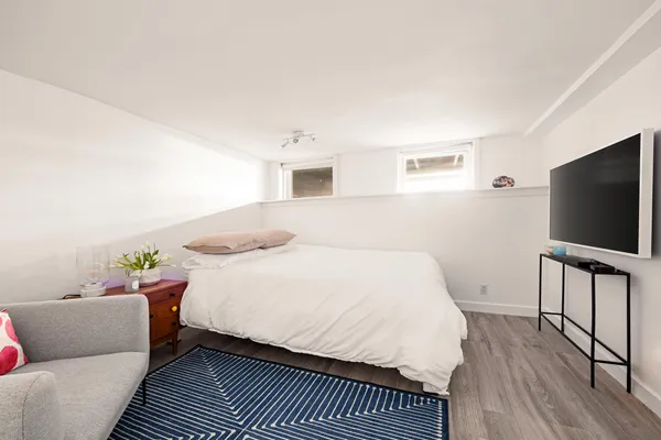 a bedroom with a bed and a flat screen tv