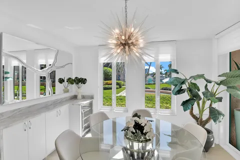 a living room filled with furniture chandelier and a large window