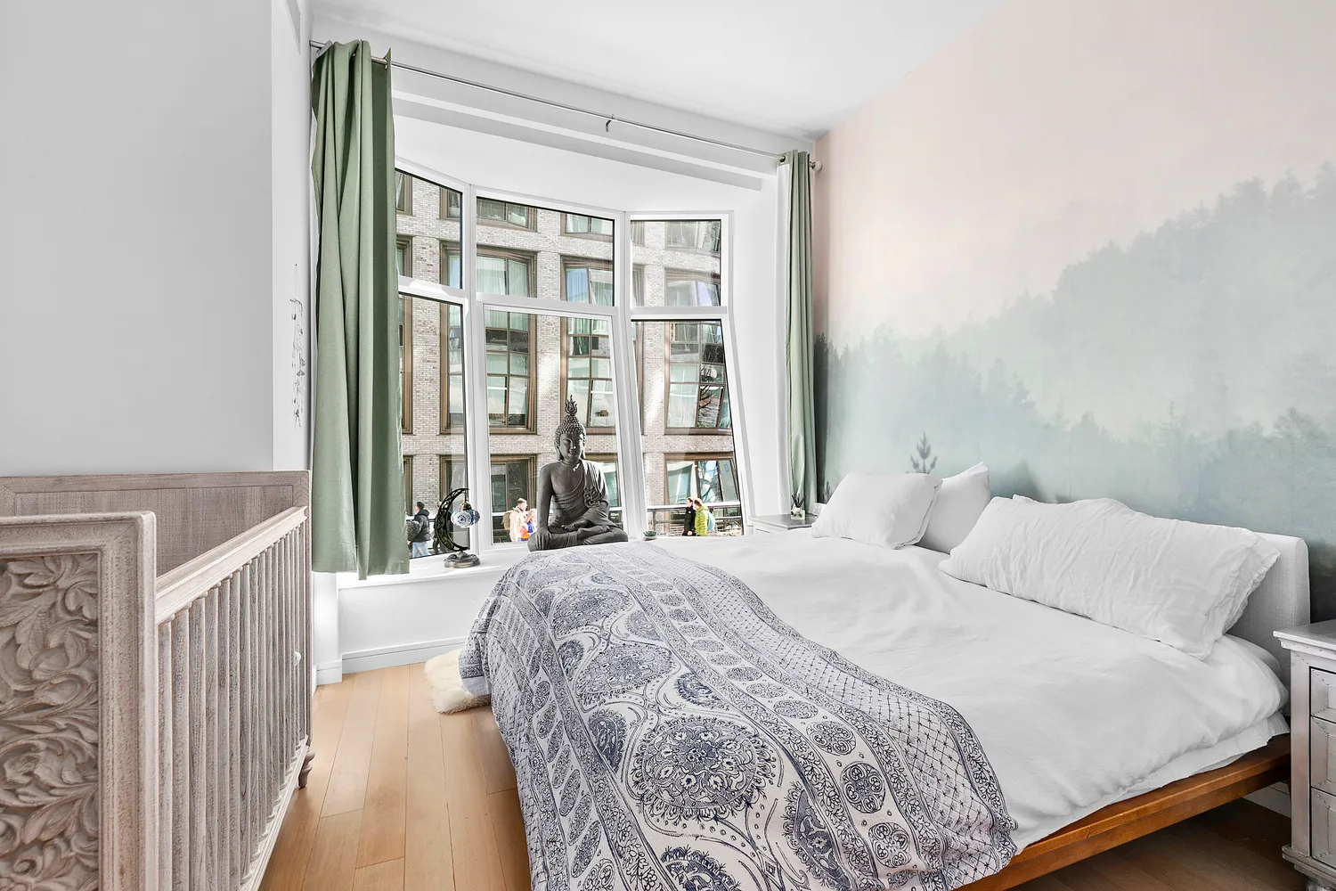 a bedroom with a bed and a large window