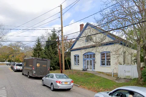a car parked in front of white house