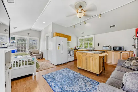 a spacious bathroom with a granite countertop sink a mirror and a vanity