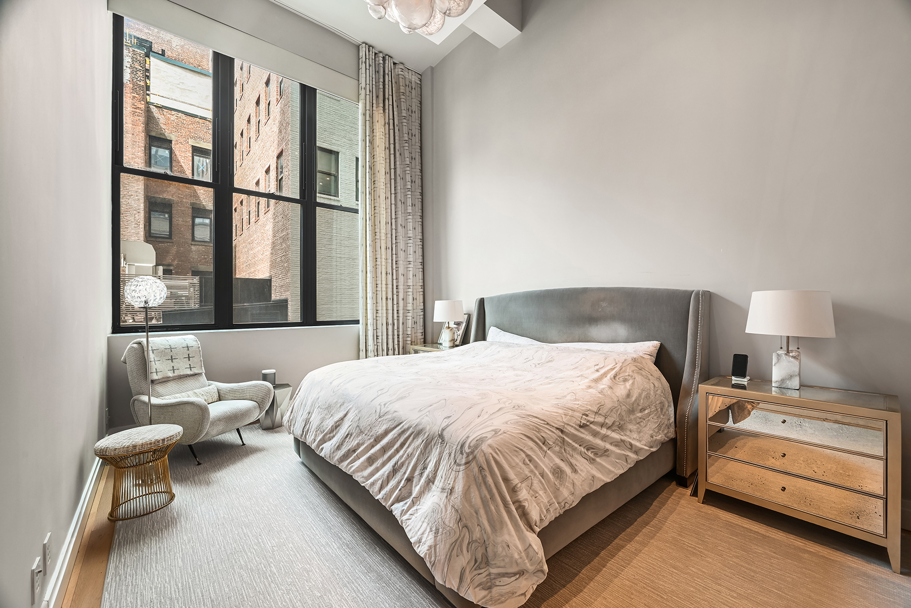 421 Hudson Street, Unit 318 Manhattan, NY 10014 - Photo 9 of 12 a bedroom with a bed and a window