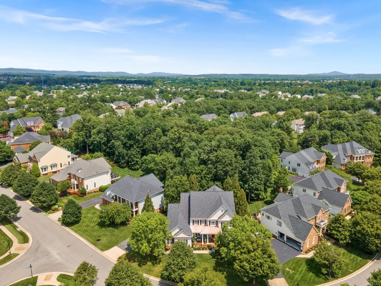 an aerial view of a house with garden space and street view