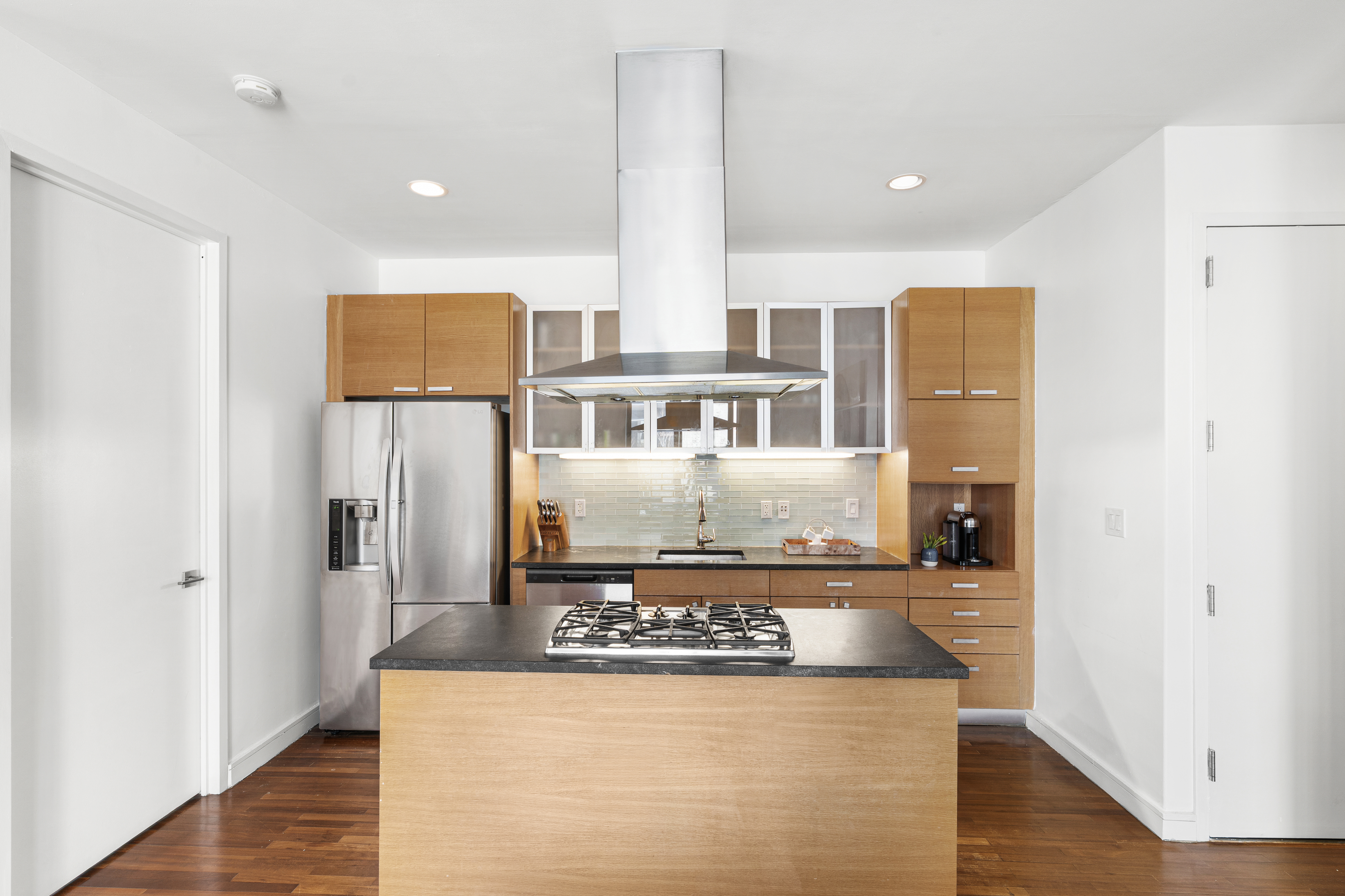 552 West 43rd Street, Unit 3A Manhattan, NY 10036 - Photo 4 of 11 a kitchen with stainless steel appliances granite countertop a refrigerator and a stove