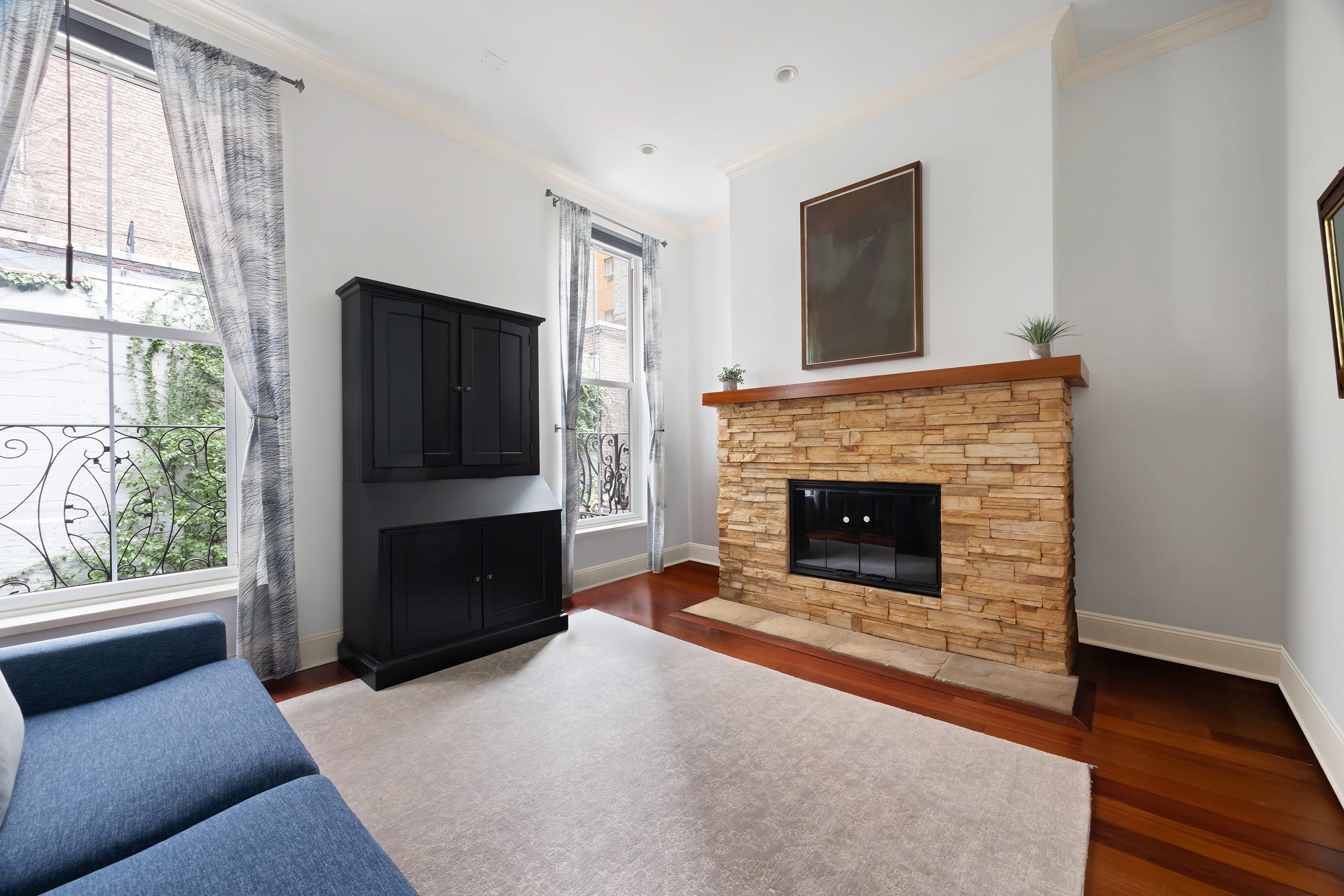 217 West 22nd Street Manhattan, NY 10011 - Photo 9 of 16 a living room with a fireplace and a flat screen tv