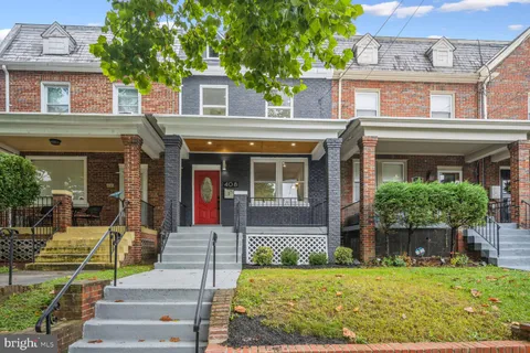 front view of a brick house with a yard
