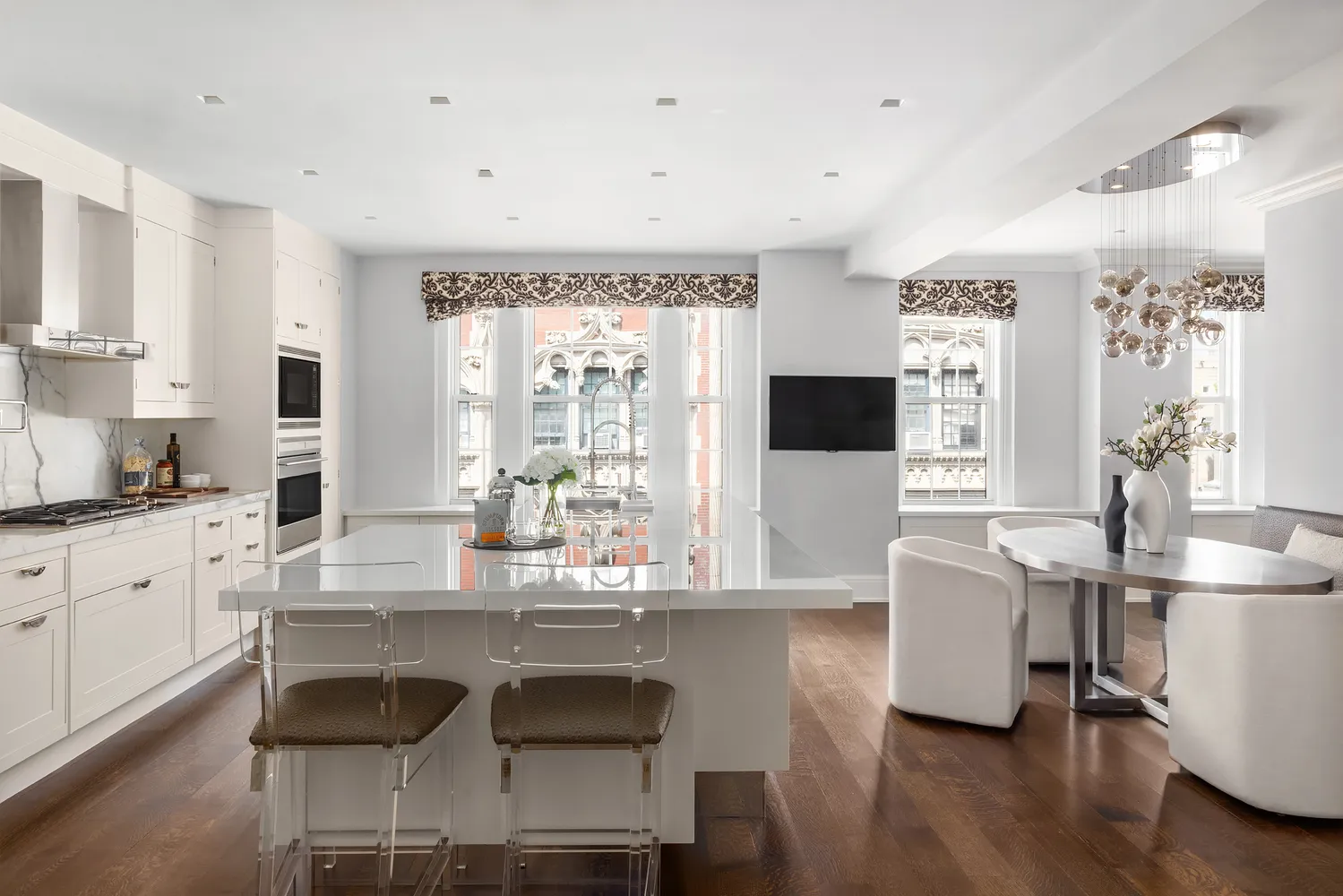 a kitchen with granite countertop a table chairs stove and sink
